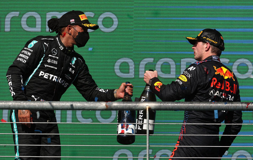 AUSTIN, TEXAS - OCTOBER 24: Race winner Max Verstappen of Netherlands and Red Bull Racing and second placed Lewis Hamilton of Great Britain and Mercedes GP celebrate on the podium during the F1 Grand Prix of USA at Circuit of The Americas on October 24, 2021 in Austin, Texas. (Photo by Chris Graythen/Getty Images) // Getty Images / Red Bull Content Pool  // SI202110240918 // Usage for editorial use only //